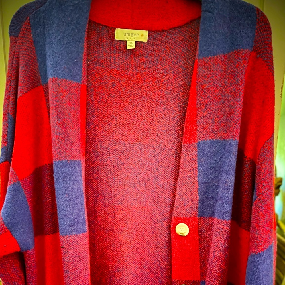 UMGEE knee length with pockets to button in front. Super warm.